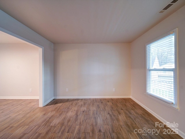 spare room with hardwood / wood-style floors