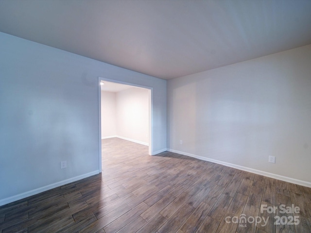 empty room featuring dark wood-type flooring