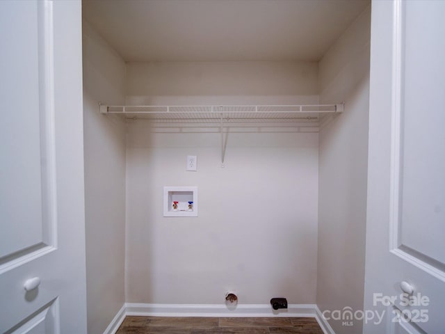 washroom with dark hardwood / wood-style floors and hookup for a washing machine