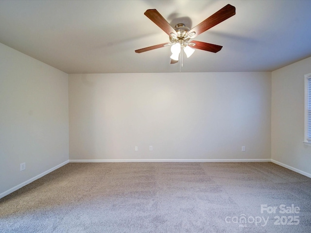 carpeted spare room with ceiling fan