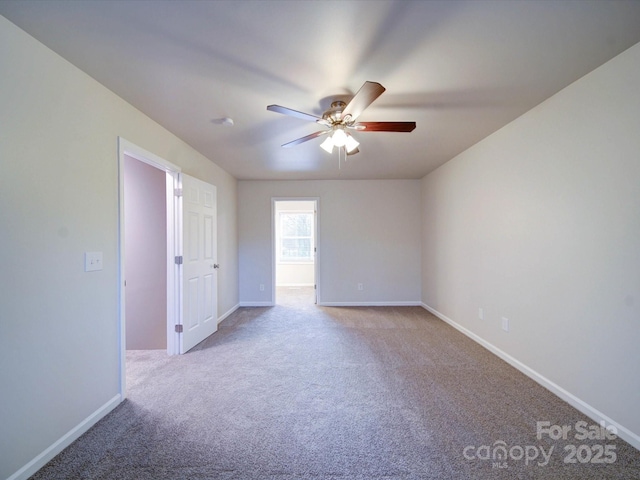 spare room featuring ceiling fan and light carpet