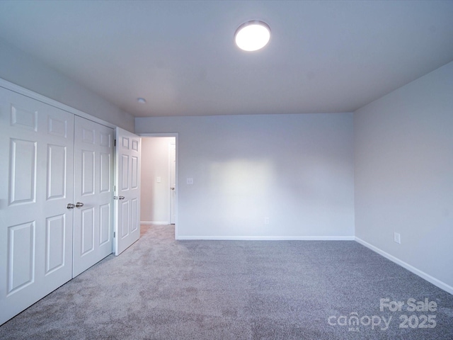 unfurnished bedroom featuring a closet and carpet flooring