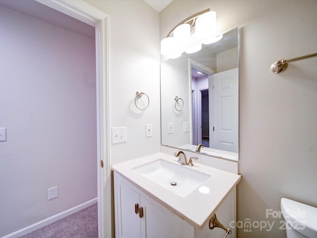 bathroom with toilet and vanity