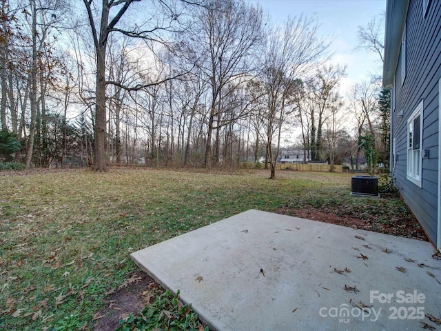 view of yard featuring cooling unit and a patio