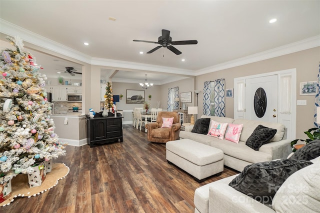 living room with crown molding, sink, dark wood-type flooring, and ceiling fan with notable chandelier