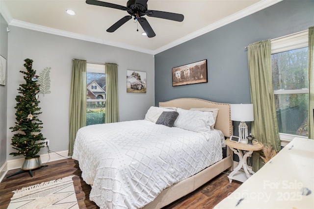 bedroom featuring ceiling fan, dark hardwood / wood-style floors, and crown molding