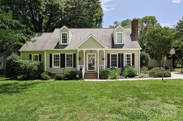 cape cod house with a front lawn