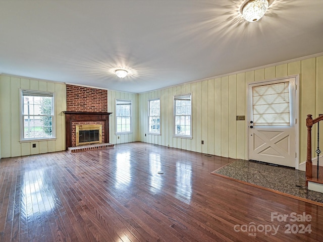 unfurnished living room featuring dark hardwood / wood-style floors and a fireplace