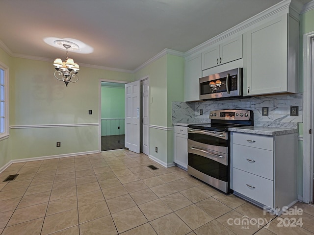 kitchen with white cabinets, decorative backsplash, ornamental molding, a notable chandelier, and stainless steel appliances