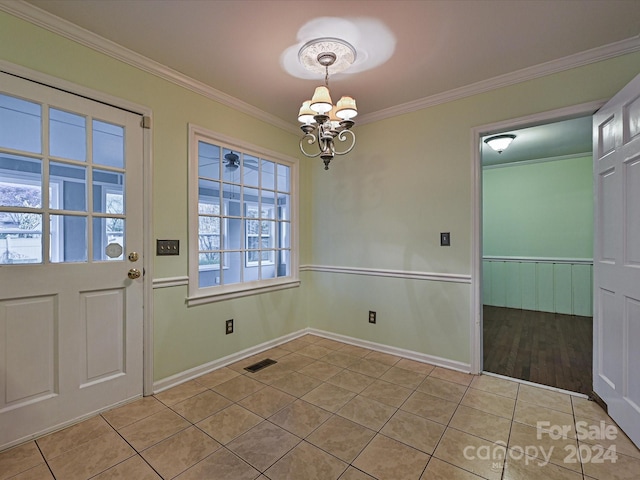 unfurnished dining area featuring light tile patterned floors, an inviting chandelier, and crown molding