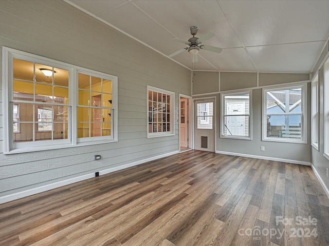 unfurnished sunroom with ceiling fan and vaulted ceiling