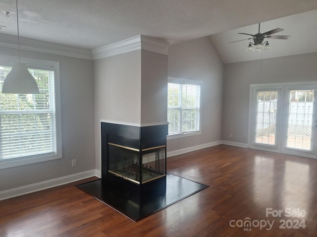 unfurnished living room with lofted ceiling, a multi sided fireplace, dark hardwood / wood-style floors, ceiling fan, and a textured ceiling