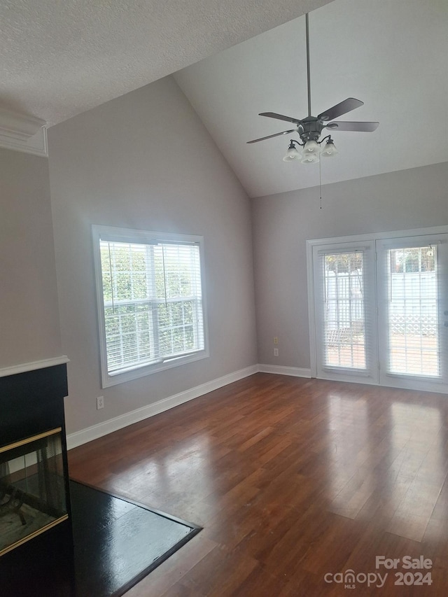 unfurnished living room with hardwood / wood-style floors, a textured ceiling, high vaulted ceiling, and ceiling fan