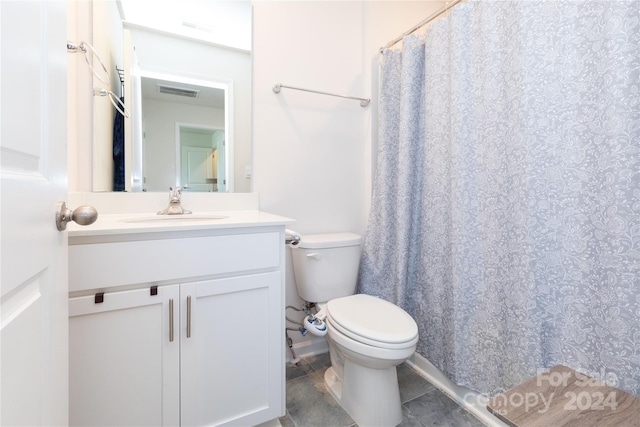 bathroom with tile patterned floors, vanity, and toilet