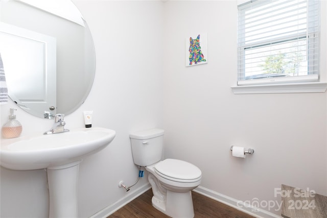 bathroom featuring hardwood / wood-style floors and toilet