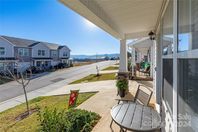 view of patio / terrace featuring a mountain view and a porch