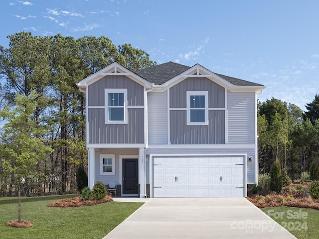 view of front facade with a front yard and a garage