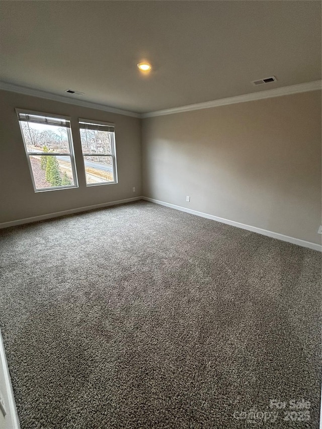 empty room with visible vents, ornamental molding, and baseboards