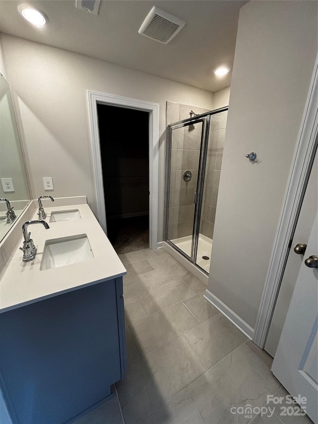 full bath featuring a stall shower, visible vents, and a sink