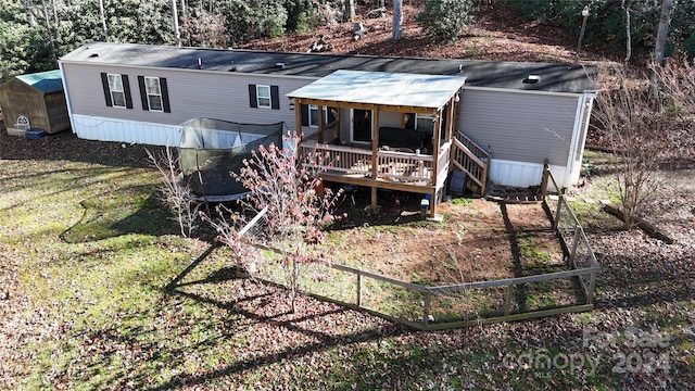 back of house with a yard and a deck