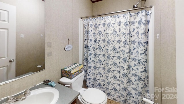 bathroom with walk in shower, vanity, and toilet