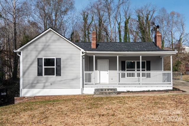 ranch-style house featuring a porch and a front yard