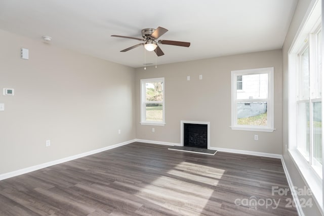 unfurnished living room featuring dark hardwood / wood-style floors and ceiling fan