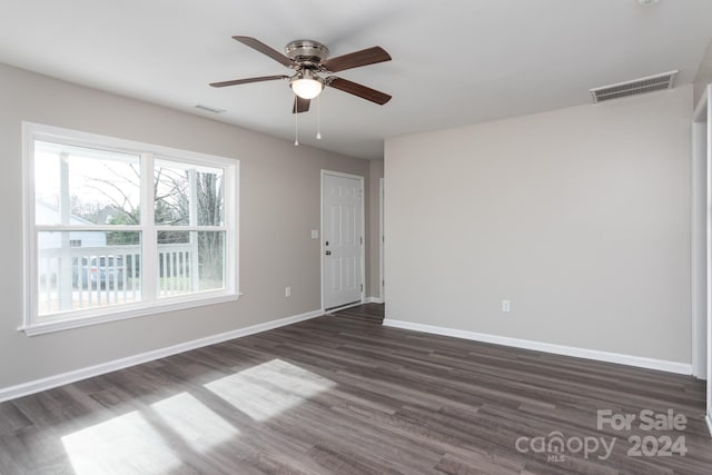 empty room with dark hardwood / wood-style floors and ceiling fan