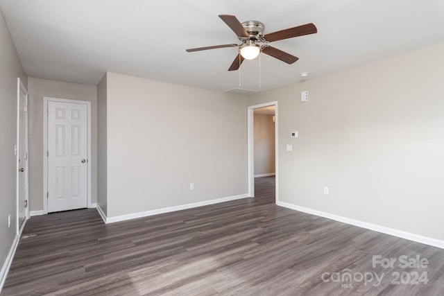 spare room with ceiling fan and dark hardwood / wood-style flooring