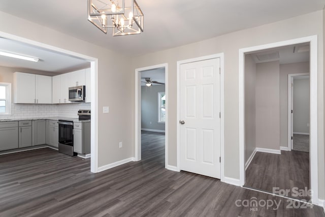 kitchen featuring decorative backsplash, pendant lighting, stainless steel appliances, and dark hardwood / wood-style floors