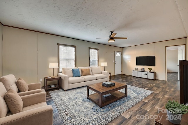 living room featuring a textured ceiling, dark hardwood / wood-style floors, ceiling fan, and ornamental molding