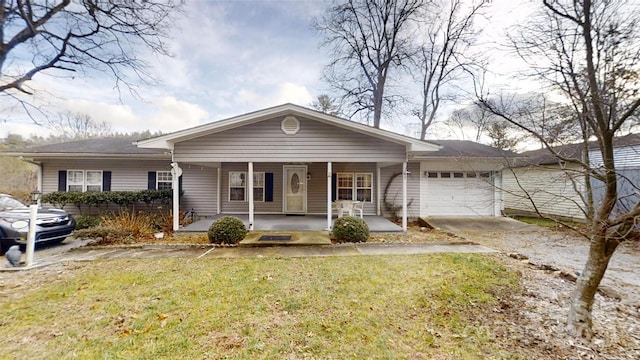 view of front of home featuring a front yard, a porch, and a garage