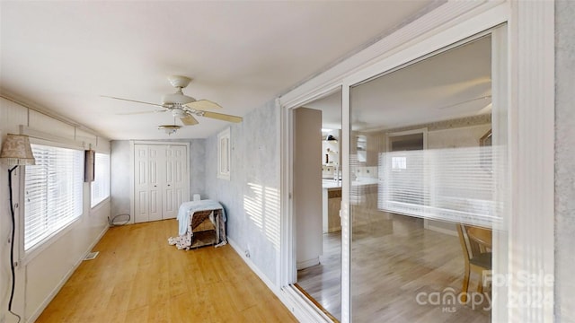 corridor with light hardwood / wood-style floors