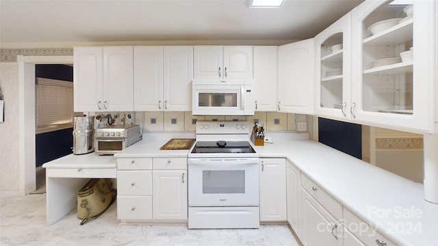 kitchen featuring white cabinets, white appliances, and tasteful backsplash