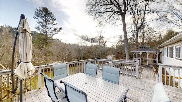 wooden terrace featuring a gazebo