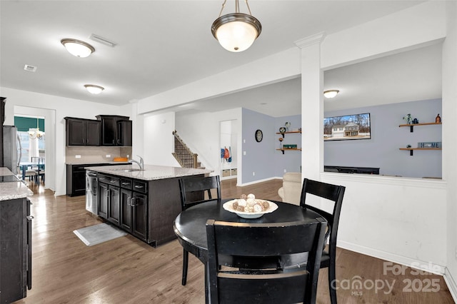 dining area with sink and dark wood-type flooring