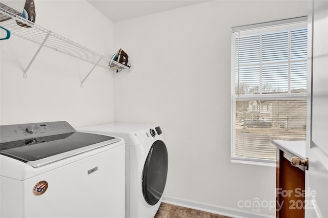 clothes washing area with washer and clothes dryer