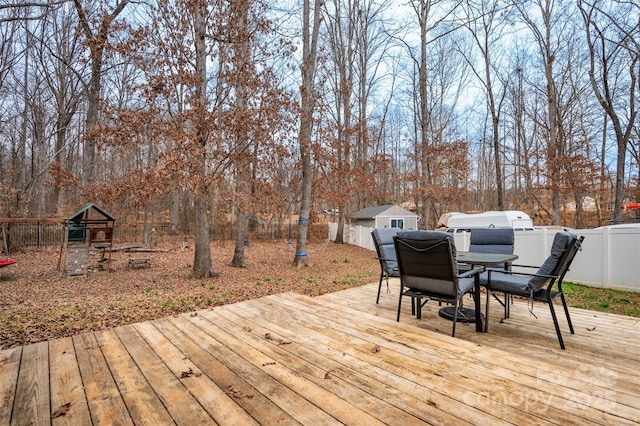 wooden terrace featuring a shed