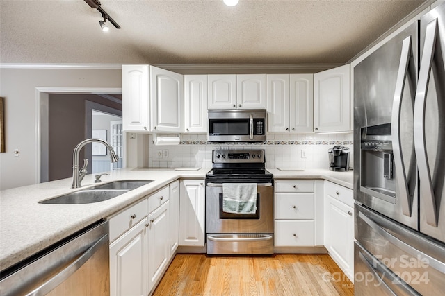 kitchen with white cabinets, stainless steel appliances, and sink