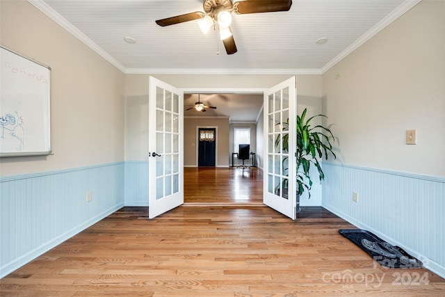 unfurnished room with french doors, light hardwood / wood-style floors, and ornamental molding