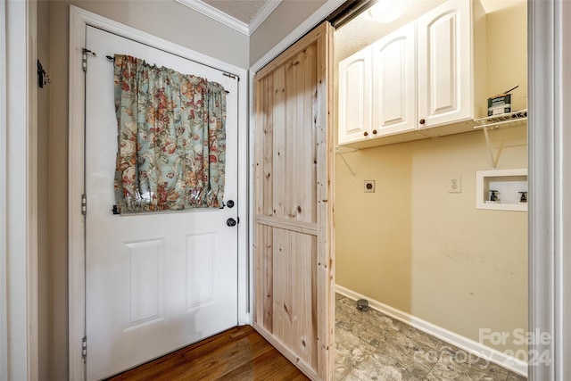 laundry area with cabinets, crown molding, washer hookup, hookup for an electric dryer, and dark hardwood / wood-style flooring