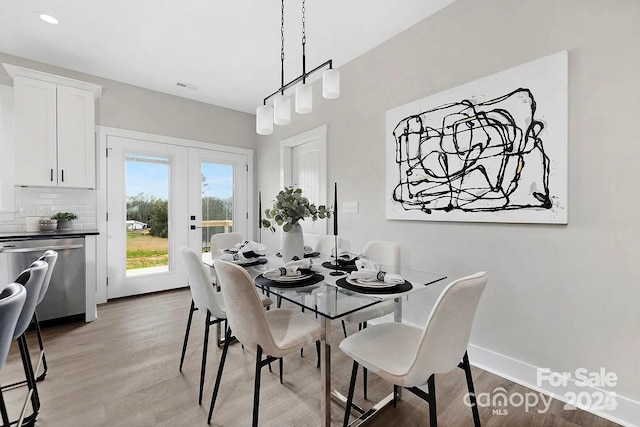 dining area with french doors, light wood finished floors, recessed lighting, visible vents, and baseboards