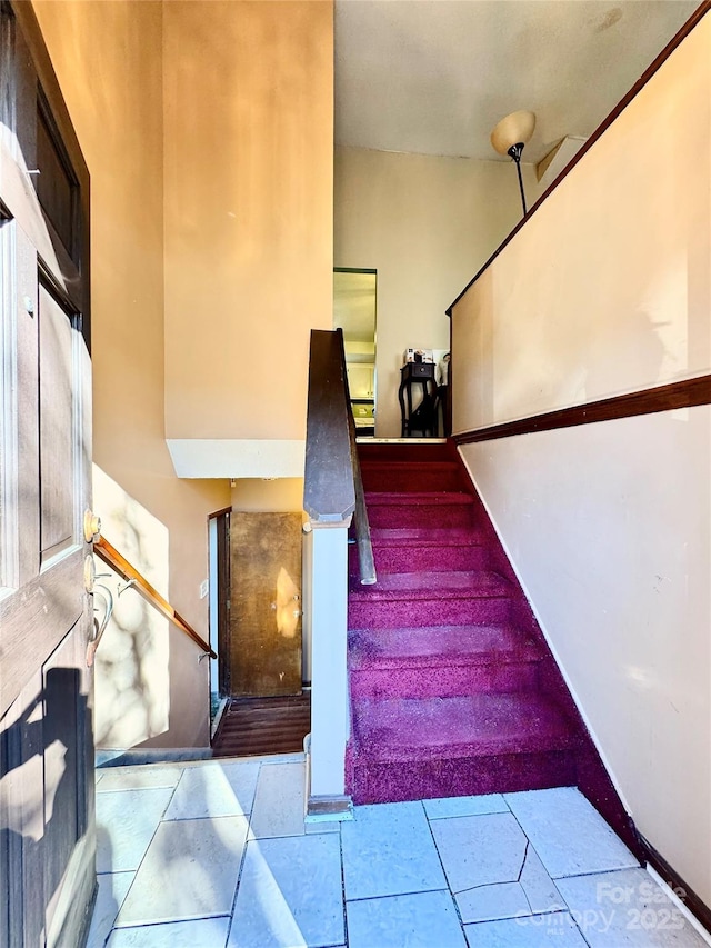 staircase with tile patterned flooring