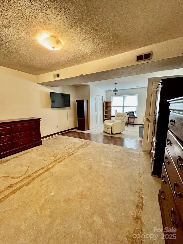 unfurnished living room featuring a textured ceiling