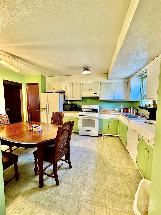 kitchen featuring sink, tile countertops, a textured ceiling, and white appliances