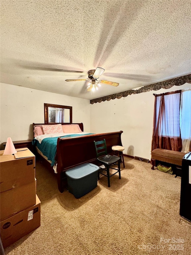 carpeted bedroom with a textured ceiling and ceiling fan