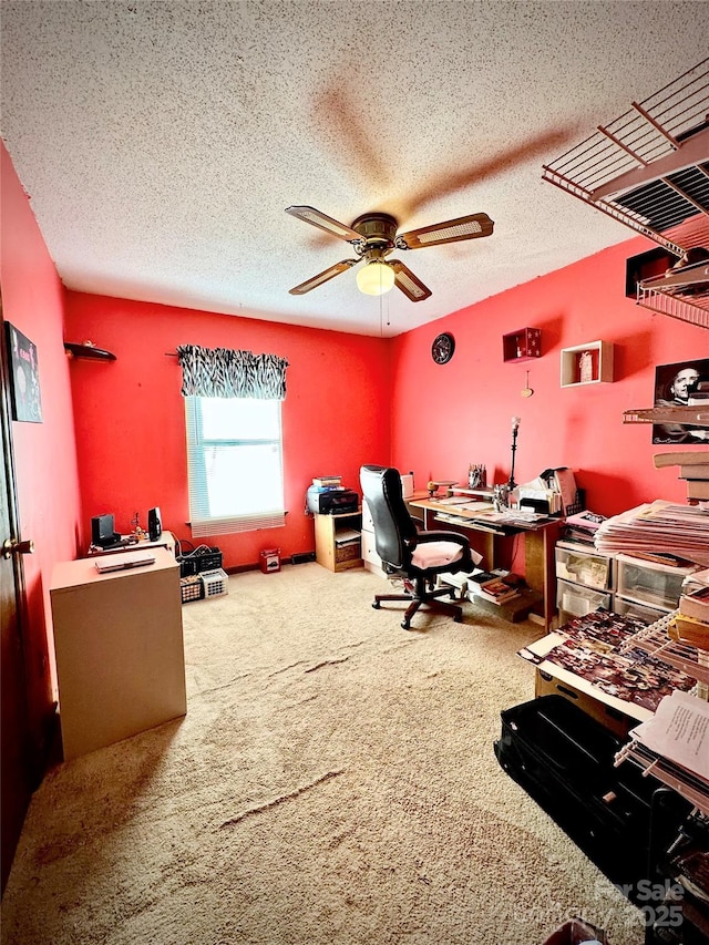 home office with ceiling fan, carpet floors, and a textured ceiling