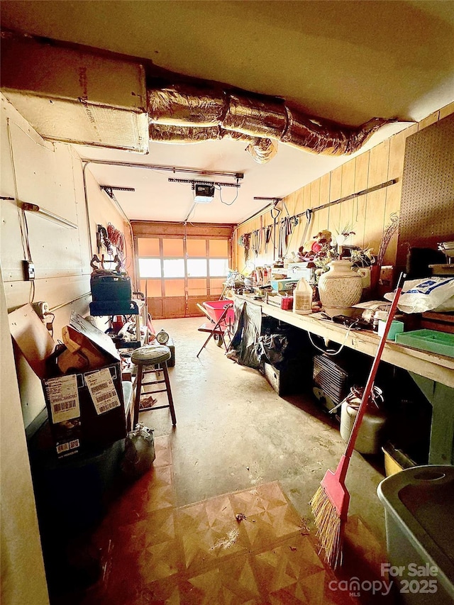 garage featuring a garage door opener and a workshop area