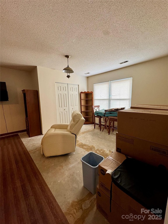 bedroom with ceiling fan, a closet, and a textured ceiling