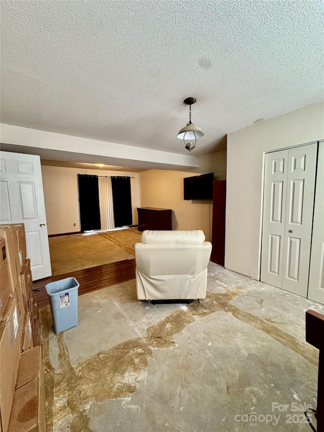 unfurnished living room with a textured ceiling